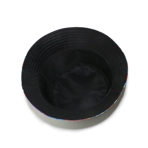 Close-up of reversible bucket hat showing black inner lining and colorful printed brim
