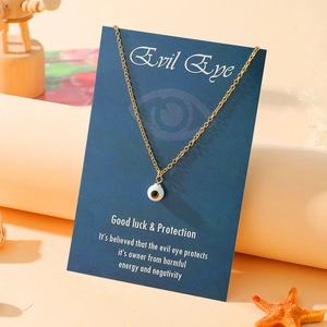 Detailed view of the Evil Eye pendant necklace on a blue good luck protection gift card