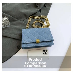 Close-up of light blue denim crossbody bag with quilted pattern and gold chain strap