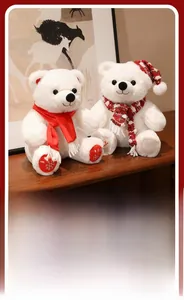 Detail of plush white polar bears with Christmas scarves and red hat on wooden surface