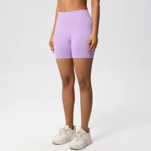 Detail view of high-waist light purple seamless yoga shorts with peach lift effect