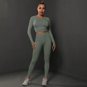 Detail of sage green seamless yoga set featuring thumb hole cuffs and high-waist leggings