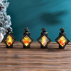 Close-up of four bronze Christmas lanterns with warm LED lights and holiday patterns
