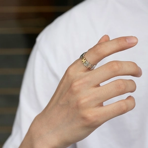 Unique puzzle pieces interlocking ring in silver and gold bicolor finish on model