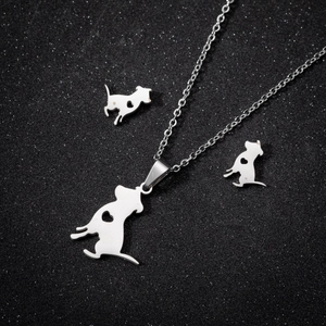 Three-piece stainless steel jewelry set with dog silhouettes and heart cutouts on black background