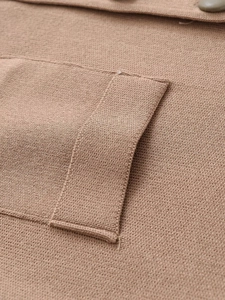 Detailed macro view of khaki knit fabric featuring a patch pocket and matching button