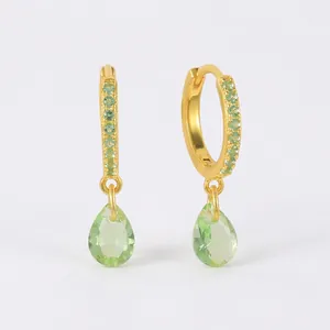 Close-up of S925 sterling silver gold hoop earrings with green pear-cut gemstones