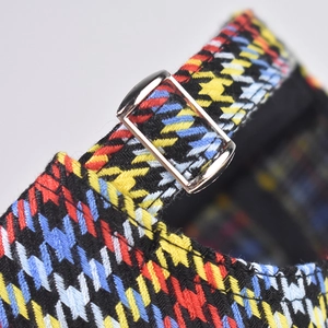 Detail of adjustable silver metal buckle on colorful houndstooth pattern baseball cap