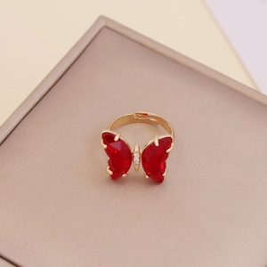 Adjustable gold butterfly ring with red zircon wings and small sparkling diamonds