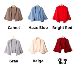 Selection of knitted cashmere ponchos in camel, blue, red, grey, beige and wine red