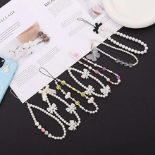 Detail of beaded mobile phone lanyards with faux pearls and butterfly heart charms