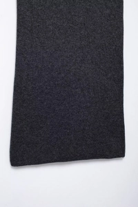 Close-up of deep gray diamond pattern knit fabric texture showing high-quality stitching