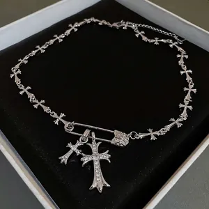 Silver punk cross necklace featuring a zircon safety pin pendant on a metal chain link