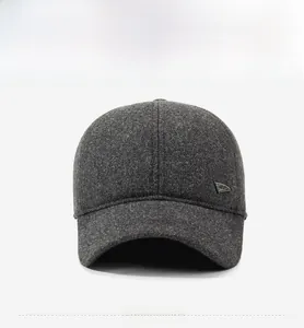 Detailed view of dark grey wool baseball cap with silver metal triangle decoration