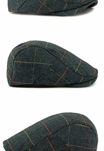 Close-up of herringbone pattern and stitching on a navy blue wool flat cap for men