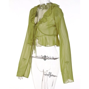 Detail of green sheer long sleeve top with ruffle edges and front tie closure