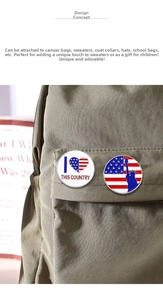Detail of USA flag and Statue of Liberty enamel pins pinned on a canvas backpack