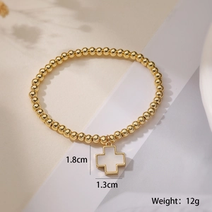 Close-up of 18K gold-plated beaded elastic bracelet with a white inlaid cross pendant