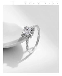 Macro shot of S925 sterling silver ring with square princess cut gemstone and engraving