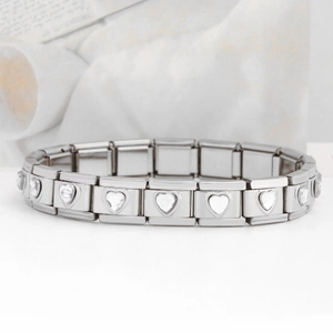 Macro view of stainless steel Italian charm bracelet with heart-shaped crystal links