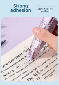 Close-up of 5mm wide purple pen-style adhesive correction tape used on a notebook
