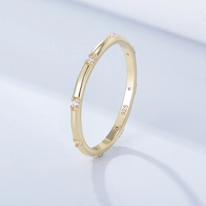 Detailed macro shot of 925 silver gold ring with inlaid zircons and hallmark engraving