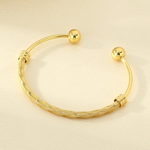 Close-up of 18K gold-plated stainless steel mesh cuff bracelet with round bead terminals