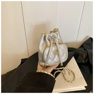 Detail of silver camellia bucket bag with quilted PU leather and chain strap