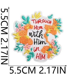 Macro detail of floral embroidered patch showing 5.5cm size and religious text