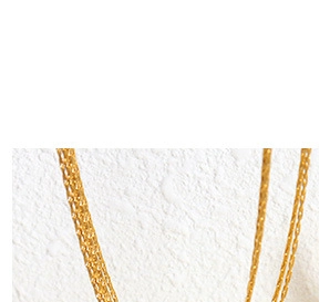Detailed macro view of 18k gold plated stainless steel layered chain with texture