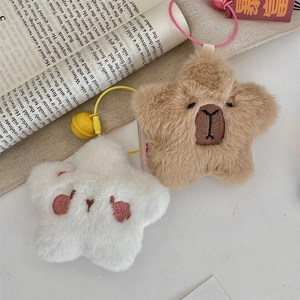 Close-up of star plush keychains in white and brown with cute embroidery and small bells