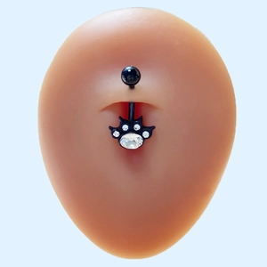 Detailed view of a black cat paw navel ring with sparkling rhinestones on silicone model