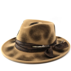Vintage khaki fedora hat with smoked texture, leather band and natural feather detail