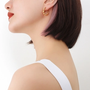 Fashionable 18k gold plated stainless steel double bead hoop earrings worn by a model