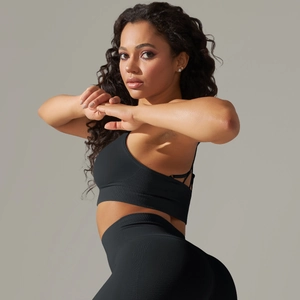 Detail showing the ribbed fabric texture of black seamless yoga top and high-waist leggings
