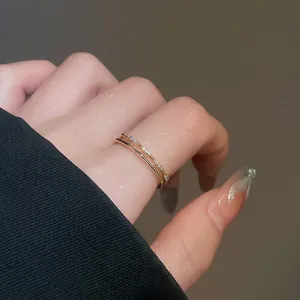 Elegant 18k gold plated double layer ring with cubic zirconia on a female finger