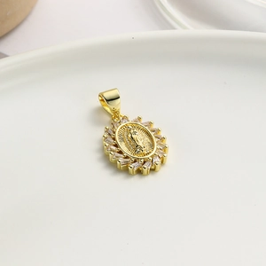 Macro shot of gold-plated oval pendant with zircon stones and engraved virgin mary icon