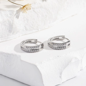 Elegant silver hoop earrings with double-row white zircons on minimalist textured stone