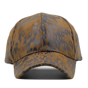 Close-up of leopard print baseball cap featuring textured brown and black animal pattern