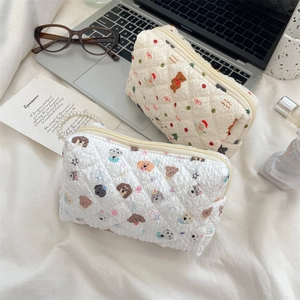 Quilted makeup pouch with cute dog and Christmas patterns on a soft background