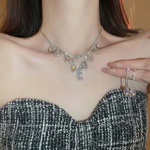 Luxurious water drop pendant necklace and earring set with shimmering pear-cut crystals