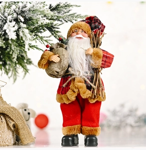 Detail of Santa Claus figurine wearing plaid coat with brown fur trim and a burlap gift sack