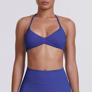Detail of navy blue seamless halter neck sports bra with ruched chest design and high elastic fit