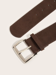 Detail of wide brown suede belt with silver metal buckle and premium stitching