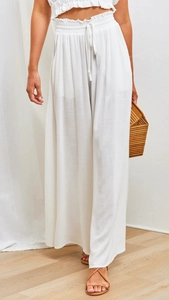 Detail of white wide-leg trousers featuring elastic high waist and drawstring design