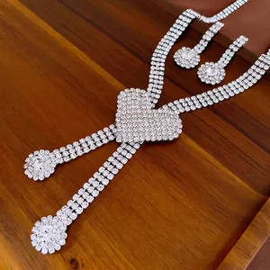 Luxury heart-shaped rhinestone necklace and earring set with shimmering silver finish