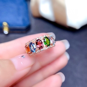 Detail of rose gold multi-stone ring featuring colorful gems and pavé zircon accents