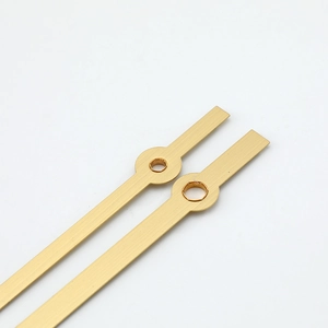 Golden brushed aluminum clock hands set with standard round holes for quartz watches