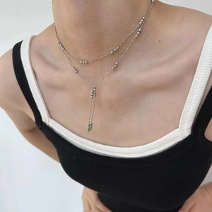 Minimalist double-layered silver bead fringe necklace showcased on a model's neck