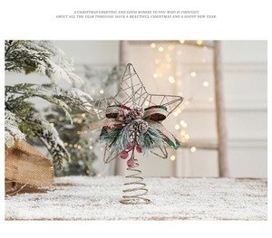 Golden wire star tree topper with plaid bow, pine cones and berries on snow background